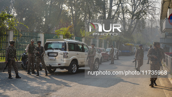 Indian security personnel stand near the site of a grenade blast at a marketplace in Srinagar, Jammu and Kashmir, on November 3, 2024. At le...