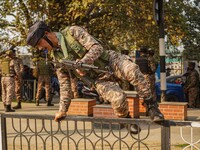 Indian security personnel inspect the site of a grenade blast at a marketplace in Srinagar, Jammu and Kashmir, on November 3, 2024. At least...