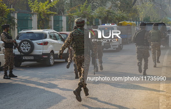 Indian security personnel run towards the site of a grenade blast at a marketplace in Srinagar, Jammu and Kashmir, on November 3, 2024. At l...