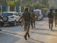 Indian security personnel run towards the site of a grenade blast at a marketplace in Srinagar, Jammu and Kashmir, on November 3, 2024. At l...