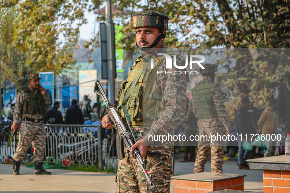 A security personnel stands near the site of a grenade blast at a marketplace in Srinagar, Jammu and Kashmir, on November 3, 2024. At least...