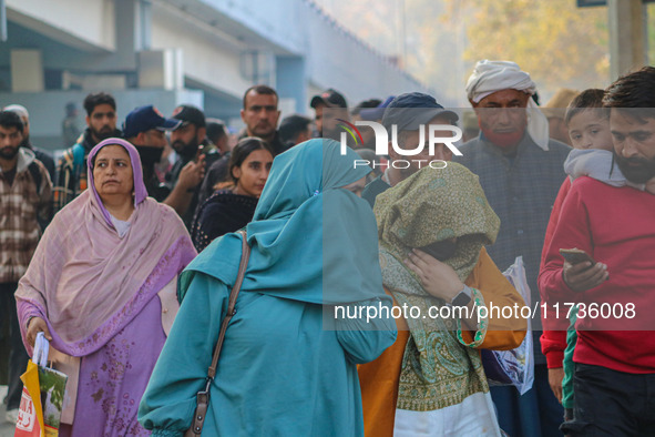 Civilians walk near the site of a grenade blast at a marketplace in Srinagar, Jammu and Kashmir, on November 3, 2024. At least ten people ar...