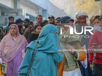 Civilians walk near the site of a grenade blast at a marketplace in Srinagar, Jammu and Kashmir, on November 3, 2024. At least ten people ar...