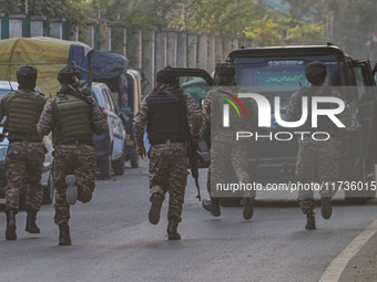 Indian security personnel run towards the site of a grenade blast at a marketplace in Srinagar, Jammu and Kashmir, on November 3, 2024. At l...