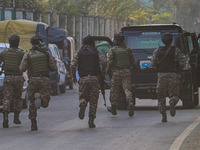 Indian security personnel run towards the site of a grenade blast at a marketplace in Srinagar, Jammu and Kashmir, on November 3, 2024. At l...