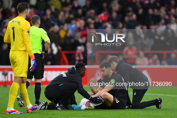 Max Kilman of West Ham United receives medical attention during the Premier League match between Nottingham Forest and West Ham United at th...