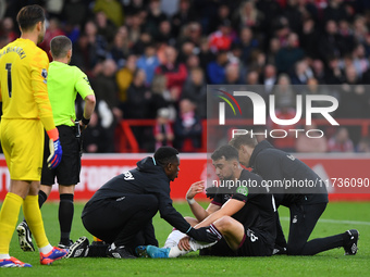 Max Kilman of West Ham United receives medical attention during the Premier League match between Nottingham Forest and West Ham United at th...