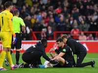 Max Kilman of West Ham United receives medical attention during the Premier League match between Nottingham Forest and West Ham United at th...