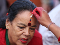 A Nepali Hindu receives a multi-colored tika on the forehead, marking the day of Bhaitika, the concluding day of Tihar, the five-day festiva...