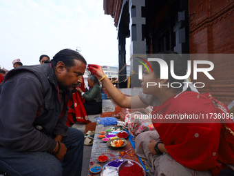 A Nepali Hindu receives a multi-colored tika on the forehead, marking the day of Bhaitika, the concluding day of Tihar, the five-day festiva...