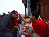 A Nepali Hindu receives a multi-colored tika on the forehead, marking the day of Bhaitika, the concluding day of Tihar, the five-day festiva...