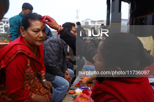 A Nepali Hindu receives a multi-colored tika on the forehead, marking the day of Bhaitika, the concluding day of Tihar, the five-day festiva...