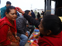 A Nepali Hindu receives a multi-colored tika on the forehead, marking the day of Bhaitika, the concluding day of Tihar, the five-day festiva...