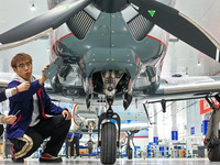 Workers assemble an aircraft at Qingdao Wanfeng Diamond Aircraft Manufacturing Co LTD in Laixi, China, on November 3, 2024. (