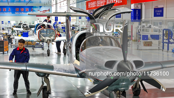 Workers assemble an aircraft at Qingdao Wanfeng Diamond Aircraft Manufacturing Co LTD in Laixi, China, on November 3, 2024. 