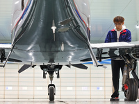 Workers assemble an aircraft at Qingdao Wanfeng Diamond Aircraft Manufacturing Co LTD in Laixi, China, on November 3, 2024. (