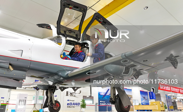 Workers adjust an aircraft at Qingdao Wanfeng Diamond Aircraft Manufacturing Co LTD in Laixi, China, on November 3, 2024. 