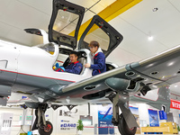 Workers adjust an aircraft at Qingdao Wanfeng Diamond Aircraft Manufacturing Co LTD in Laixi, China, on November 3, 2024. (