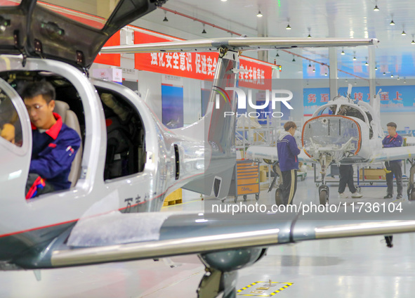 Workers assemble an aircraft at Qingdao Wanfeng Diamond Aircraft Manufacturing Co LTD in Laixi, China, on November 3, 2024. 