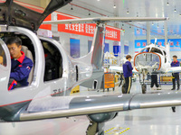 Workers assemble an aircraft at Qingdao Wanfeng Diamond Aircraft Manufacturing Co LTD in Laixi, China, on November 3, 2024. (