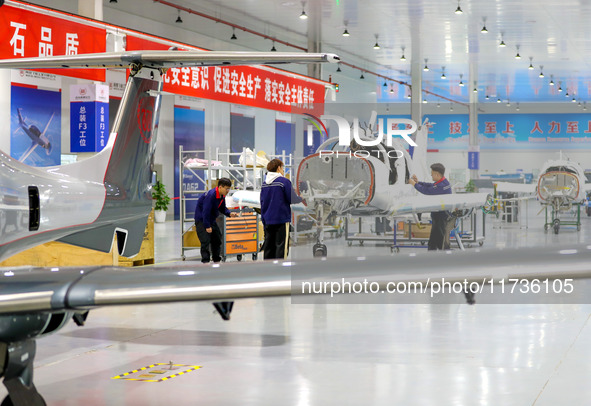 Workers assemble an aircraft at Qingdao Wanfeng Diamond Aircraft Manufacturing Co LTD in Laixi, China, on November 3, 2024. 