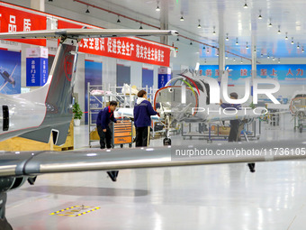 Workers assemble an aircraft at Qingdao Wanfeng Diamond Aircraft Manufacturing Co LTD in Laixi, China, on November 3, 2024. (