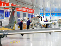 Workers assemble an aircraft at Qingdao Wanfeng Diamond Aircraft Manufacturing Co LTD in Laixi, China, on November 3, 2024. (