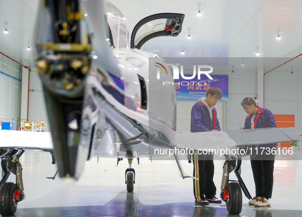 Workers assemble an aircraft at Qingdao Wanfeng Diamond Aircraft Manufacturing Co LTD in Laixi, China, on November 3, 2024. 