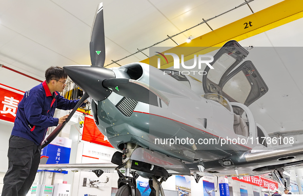 Workers assemble an aircraft at Qingdao Wanfeng Diamond Aircraft Manufacturing Co LTD in Laixi, China, on November 3, 2024. 