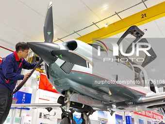 Workers assemble an aircraft at Qingdao Wanfeng Diamond Aircraft Manufacturing Co LTD in Laixi, China, on November 3, 2024. (