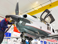 Workers assemble an aircraft at Qingdao Wanfeng Diamond Aircraft Manufacturing Co LTD in Laixi, China, on November 3, 2024. (