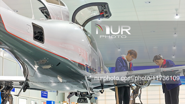 Workers assemble an aircraft at Qingdao Wanfeng Diamond Aircraft Manufacturing Co LTD in Laixi, China, on November 3, 2024. 