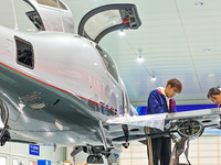 Workers assemble an aircraft at Qingdao Wanfeng Diamond Aircraft Manufacturing Co LTD in Laixi, China, on November 3, 2024. (