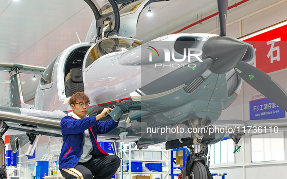 Workers assemble an aircraft at Qingdao Wanfeng Diamond Aircraft Manufacturing Co LTD in Laixi, China, on November 3, 2024. 