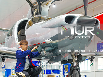 Workers assemble an aircraft at Qingdao Wanfeng Diamond Aircraft Manufacturing Co LTD in Laixi, China, on November 3, 2024. (