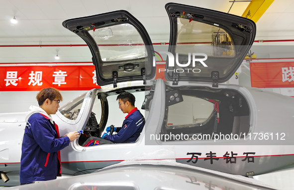 Workers assemble an aircraft at Qingdao Wanfeng Diamond Aircraft Manufacturing Co LTD in Laixi, China, on November 3, 2024. 