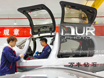 Workers assemble an aircraft at Qingdao Wanfeng Diamond Aircraft Manufacturing Co LTD in Laixi, China, on November 3, 2024. (