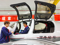 Workers assemble an aircraft at Qingdao Wanfeng Diamond Aircraft Manufacturing Co LTD in Laixi, China, on November 3, 2024. (