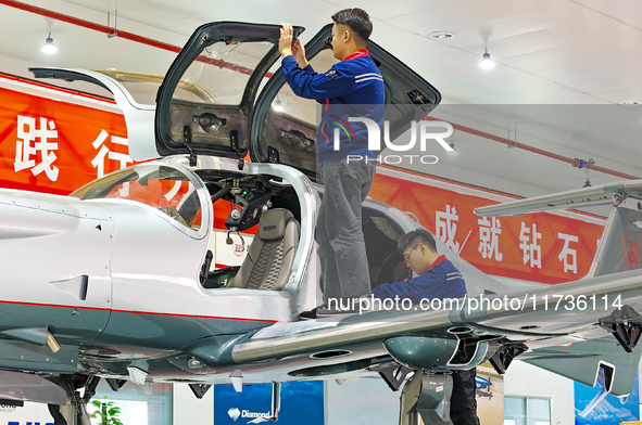 Workers assemble an aircraft at Qingdao Wanfeng Diamond Aircraft Manufacturing Co LTD in Laixi, China, on November 3, 2024. 