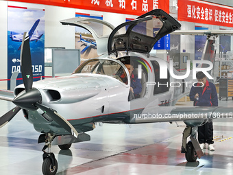 Workers assemble an aircraft at Qingdao Wanfeng Diamond Aircraft Manufacturing Co LTD in Laixi, China, on November 3, 2024. (