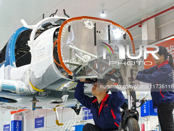 Workers assemble an aircraft at Qingdao Wanfeng Diamond Aircraft Manufacturing Co LTD in Laixi, China, on November 3, 2024. (