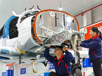 Workers assemble an aircraft at Qingdao Wanfeng Diamond Aircraft Manufacturing Co LTD in Laixi, China, on November 3, 2024. (