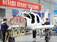 Workers assemble an aircraft at Qingdao Wanfeng Diamond Aircraft Manufacturing Co LTD in Laixi, China, on November 3, 2024. (