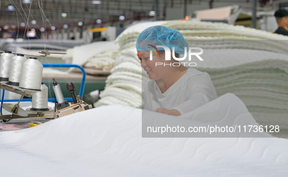 A worker makes bedding at a workshop of Wadfeng Automotive Supplies (Nantong) Co., Ltd. in Duntou town, Haian city, East China's Jiangsu pro...