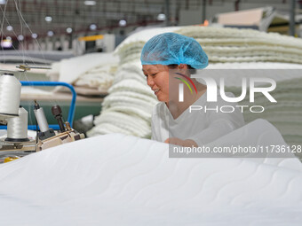 A worker makes bedding at a workshop of Wadfeng Automotive Supplies (Nantong) Co., Ltd. in Duntou town, Haian city, East China's Jiangsu pro...