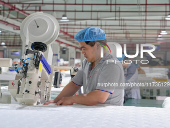 A worker makes bedding at a workshop of Wadfeng Automotive Supplies (Nantong) Co., Ltd. in Duntou town, Haian city, East China's Jiangsu pro...