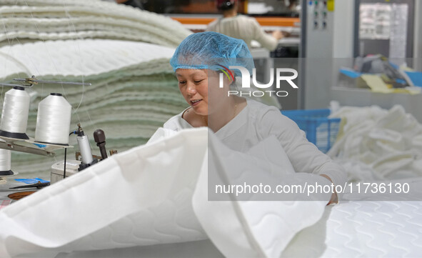 A worker makes bedding at a workshop of Wadfeng Automotive Supplies (Nantong) Co., Ltd. in Duntou town, Haian city, East China's Jiangsu pro...