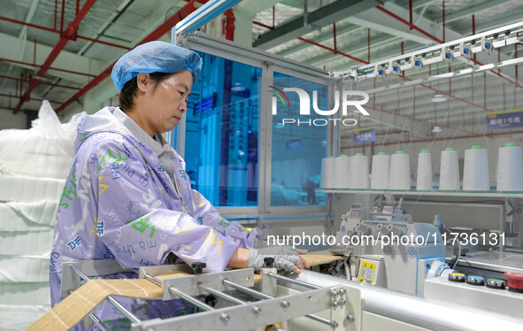 A worker makes bedding at a workshop of Wadfeng Automotive Supplies (Nantong) Co., Ltd. in Duntou town, Haian city, East China's Jiangsu pro...