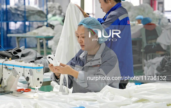 A worker makes bedding at a workshop of Wadfeng Automotive Supplies (Nantong) Co., Ltd. in Duntou town, Haian city, East China's Jiangsu pro...