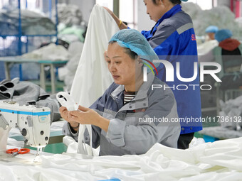 A worker makes bedding at a workshop of Wadfeng Automotive Supplies (Nantong) Co., Ltd. in Duntou town, Haian city, East China's Jiangsu pro...